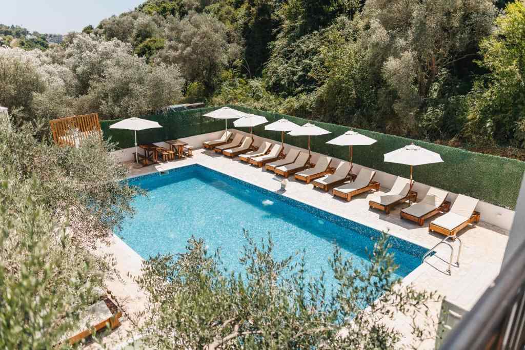 Outdoor swimming pool with sun loungers at Eman Resort, Ulcinj
